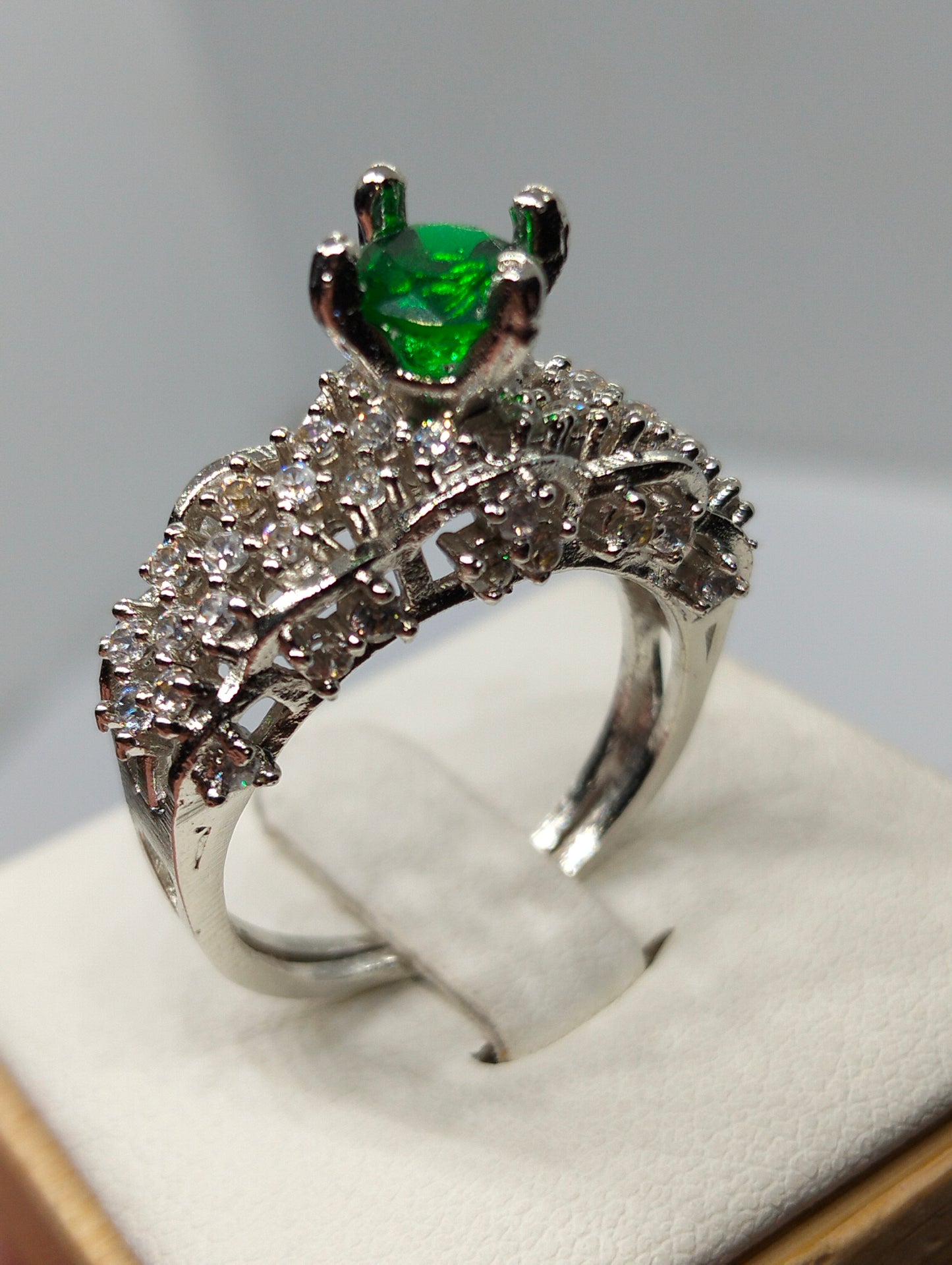 Silver rhodium plated crown ring in green stone